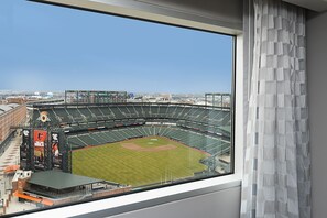 A view of a baseball stadium from inside a building, with a large window overlooking the field. - Hilton Baltimore Inner Harbor (Baltimore)