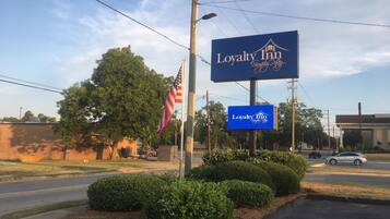 A Loyalty Inn sign with a house logo and "Simply Stay" text.