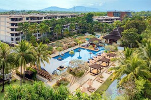A resort with multiple buildings, a central swimming pool, and lush greenery. - Marriott’s Mai Khao Resort - Phuket (Mai Khao)