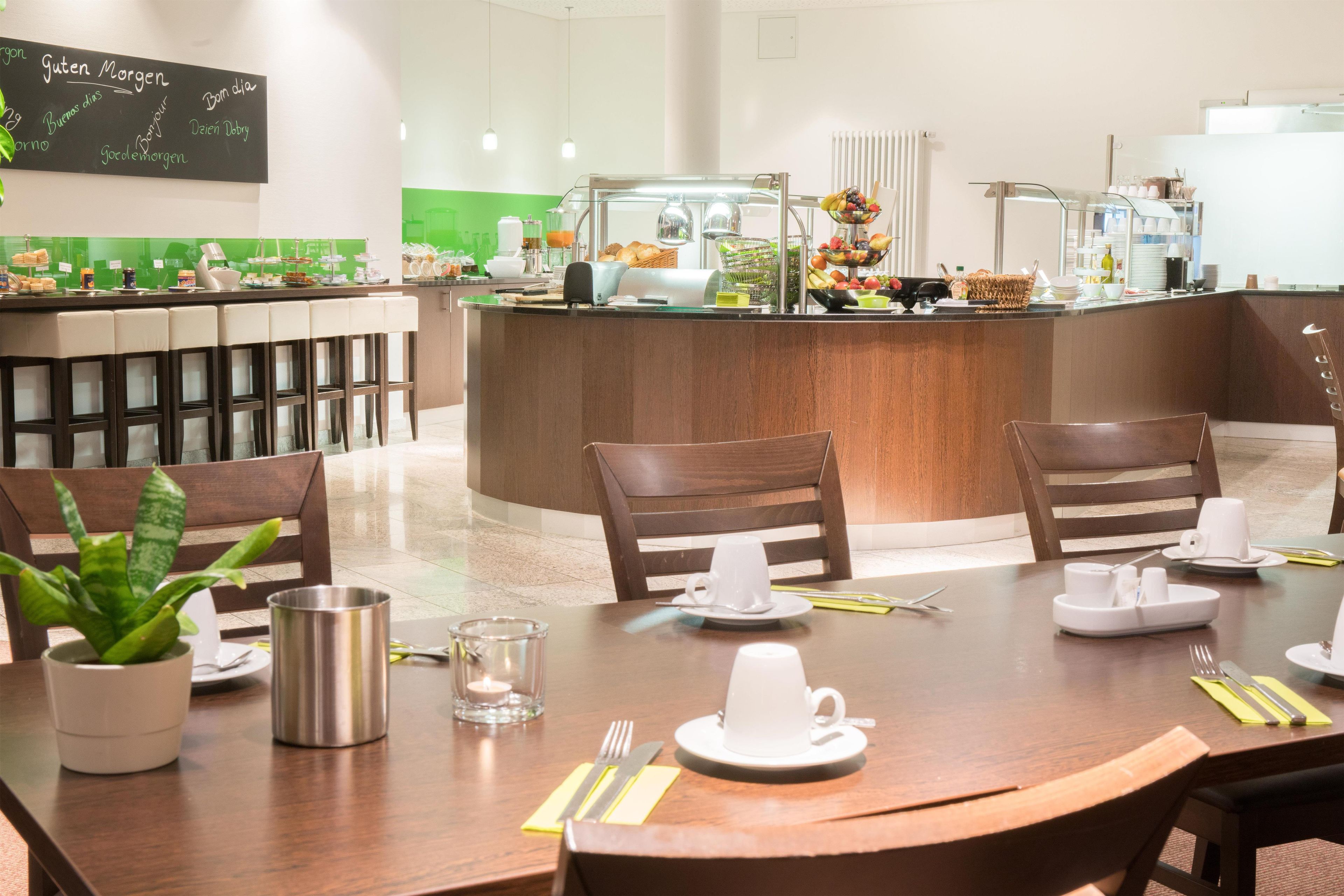 A breakfast area with a counter, seating, and a menu board.