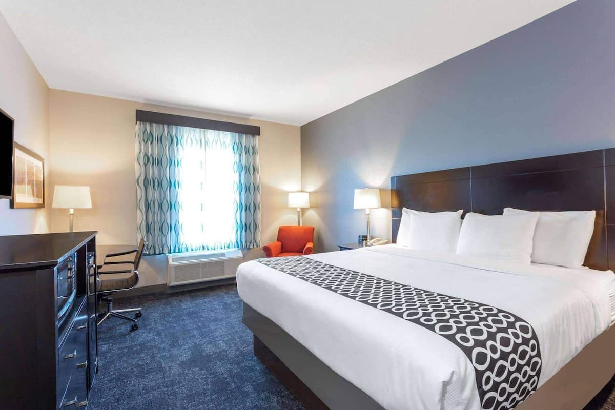 Premium bedding, desk, laptop workspace, iron/ironing board