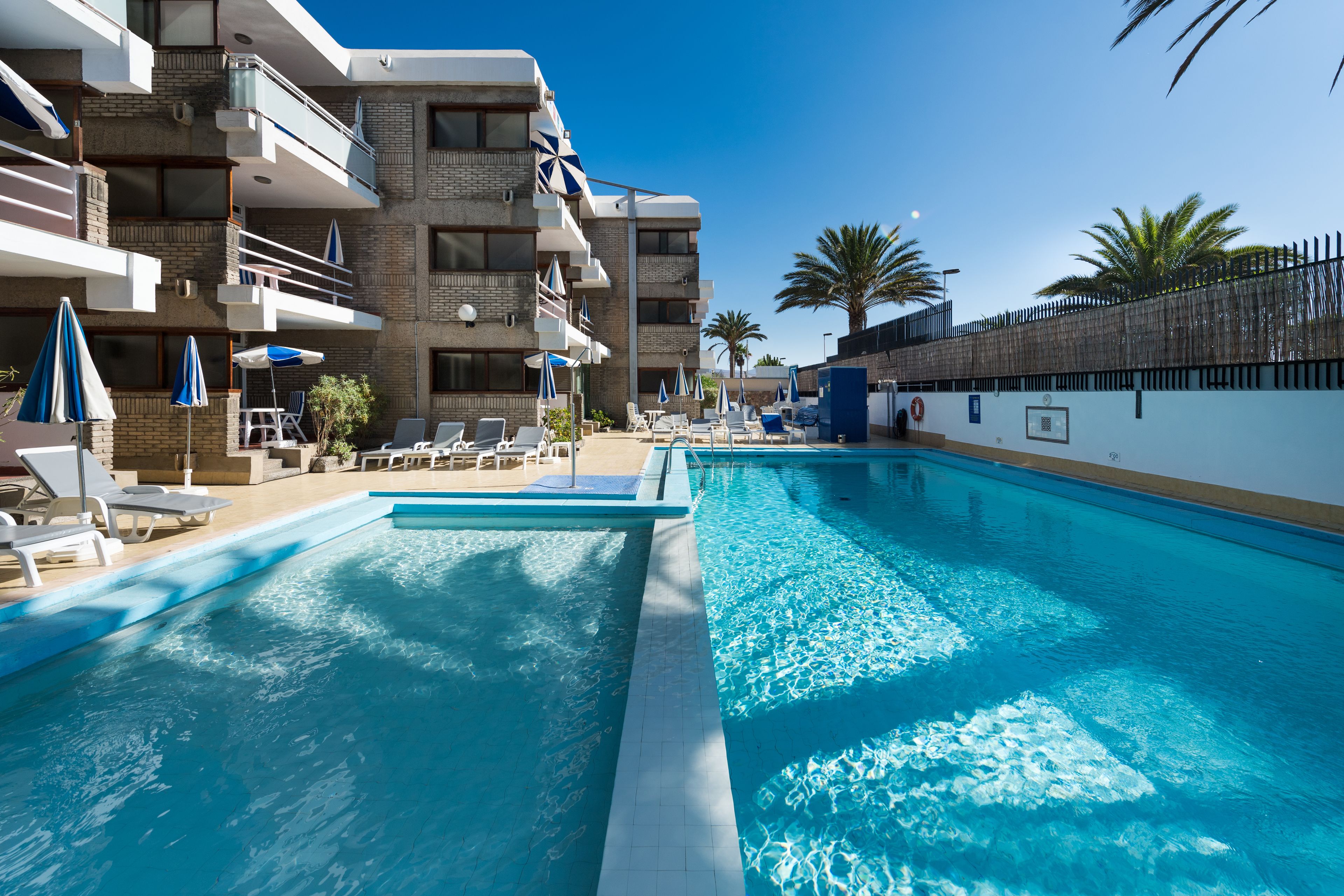 Outdoor pool, open 9:00 AM to 7:00 PM, pool umbrellas, pool loungers
