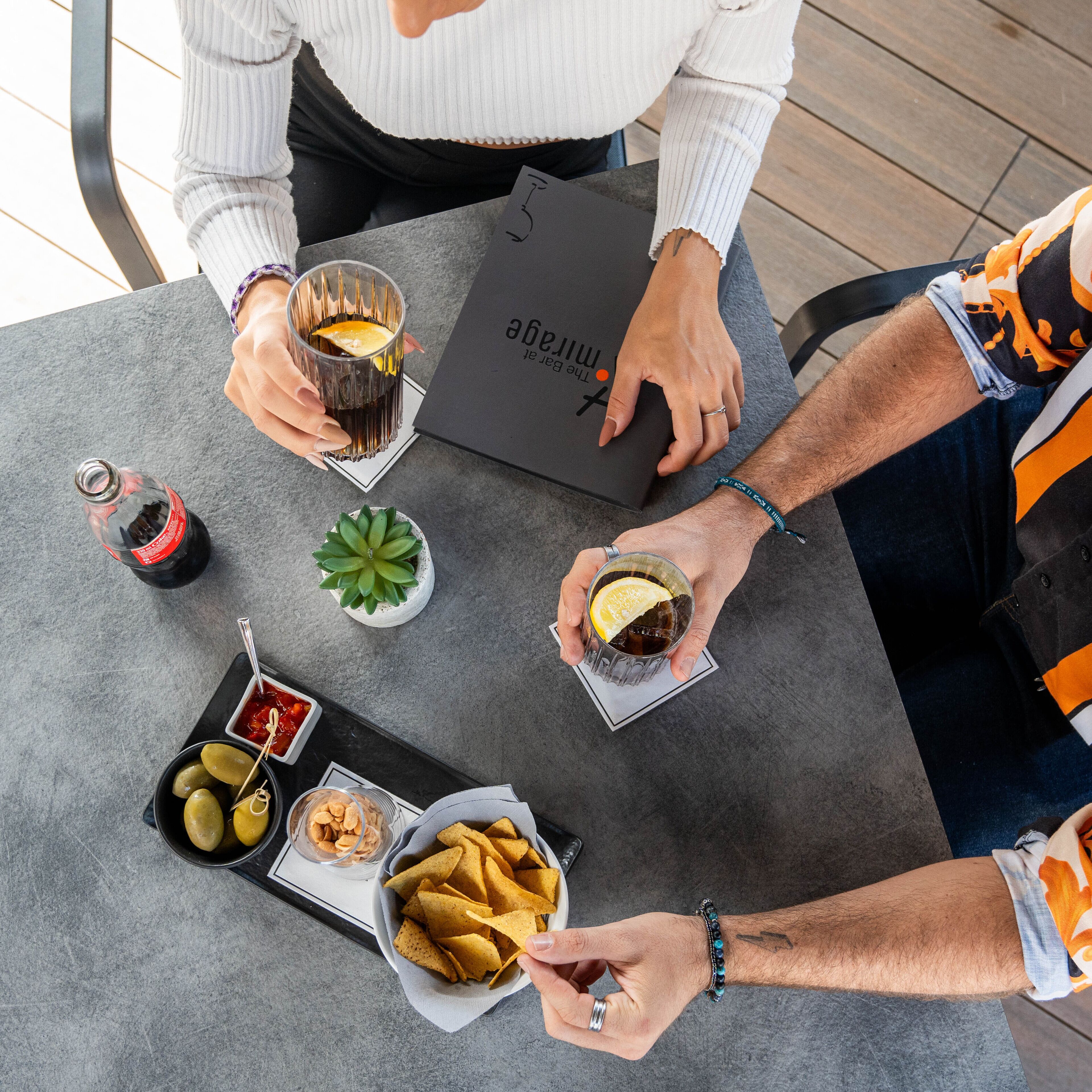 A table with snacks, drinks, and a menu.