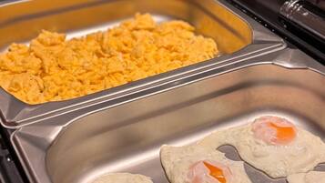 A buffet with scrambled eggs and a tray of scrambled eggs.