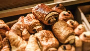 A drawer filled with various pastries, including croissants and other baked goods.