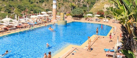 Una piscina cubierta, una piscina al aire libre de temporada, sombrillas