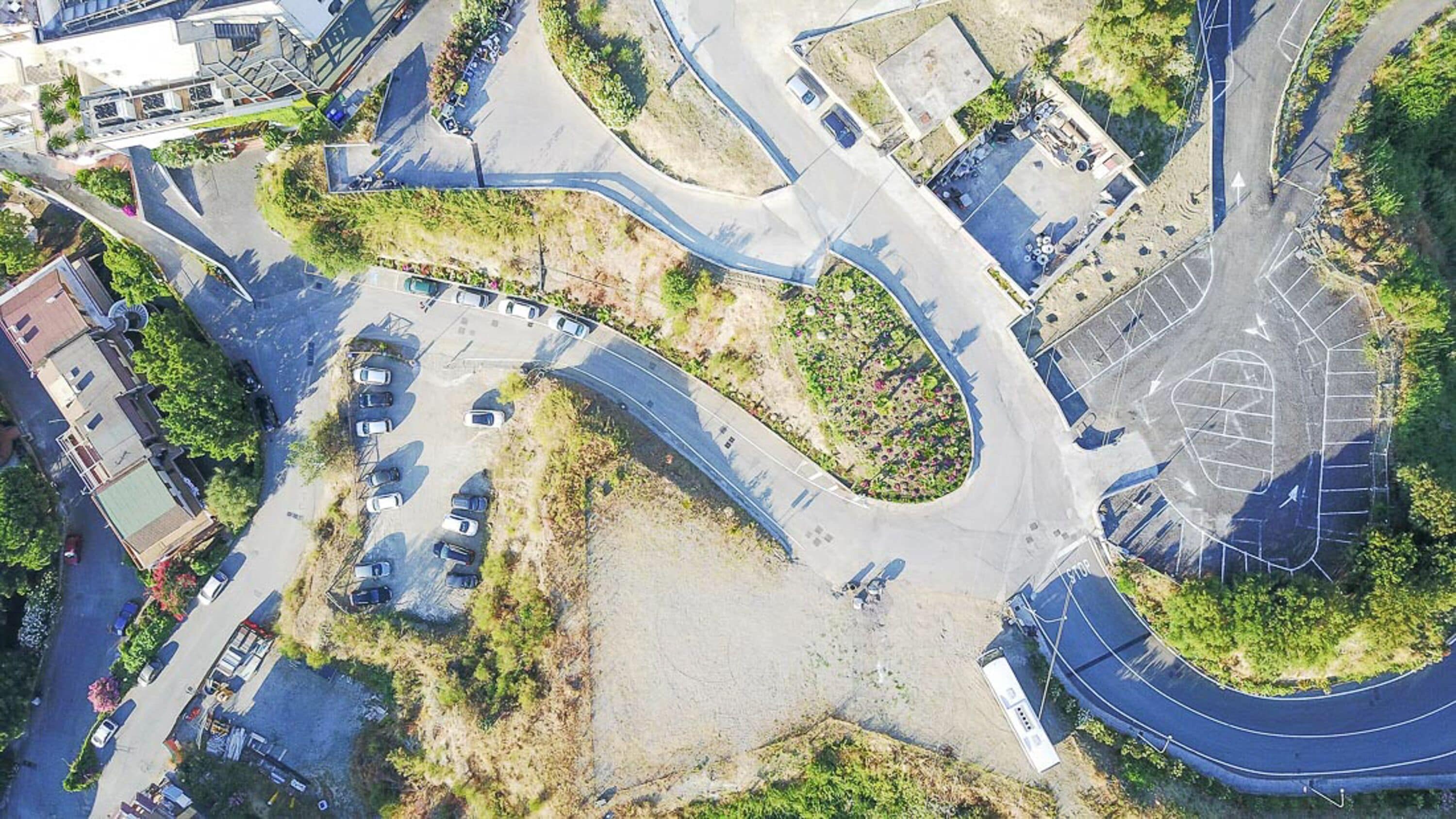 An aerial view of a complex intersection with multiple roads and parking areas.