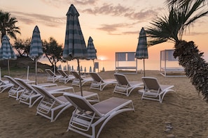 On the beach, sun-loungers, beach umbrellas, beach volleyball