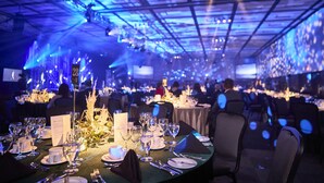 A banquet hall with tables set for a formal event, featuring a ceiling with a grid pattern and ambient lighting. - Four Points by Sheraton Levis Convention Centre (Levis)