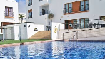 Outdoor pool, open 10:00 AM to 10:00 PM, pool umbrellas, pool loungers