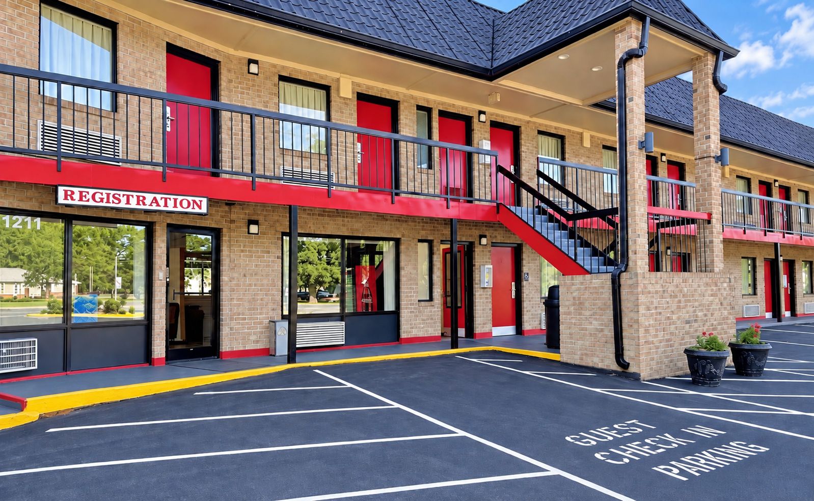 A hotel with a registration desk, a staircase, and a parking area with a check-in sign.