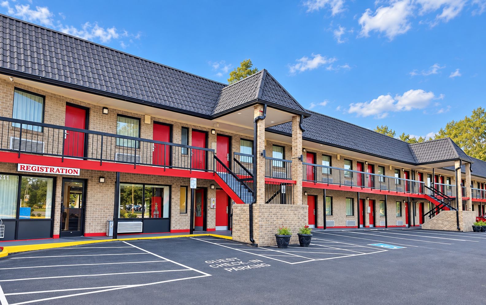 A motel with a registration desk, guest check-in parking, and a two-story building with red accents.
