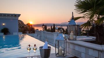 Seasonal outdoor pool, open 10:00 AM to 8:00 PM, pool umbrellas