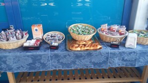A buffet table with various food items and condiments. - Beach Hotel (Diamante)
