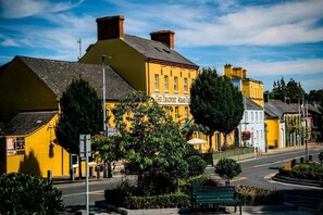 A yellow building with a sign reading 'The Deadfront Arms.'