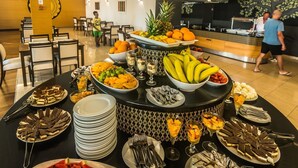 A buffet setup with various fruits, desserts, and beverages. - Family Hotel La Luna (Novalja)