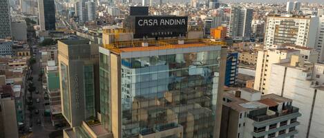 A high-rise building with a sign reading "CASA ANDINA HOTELS".