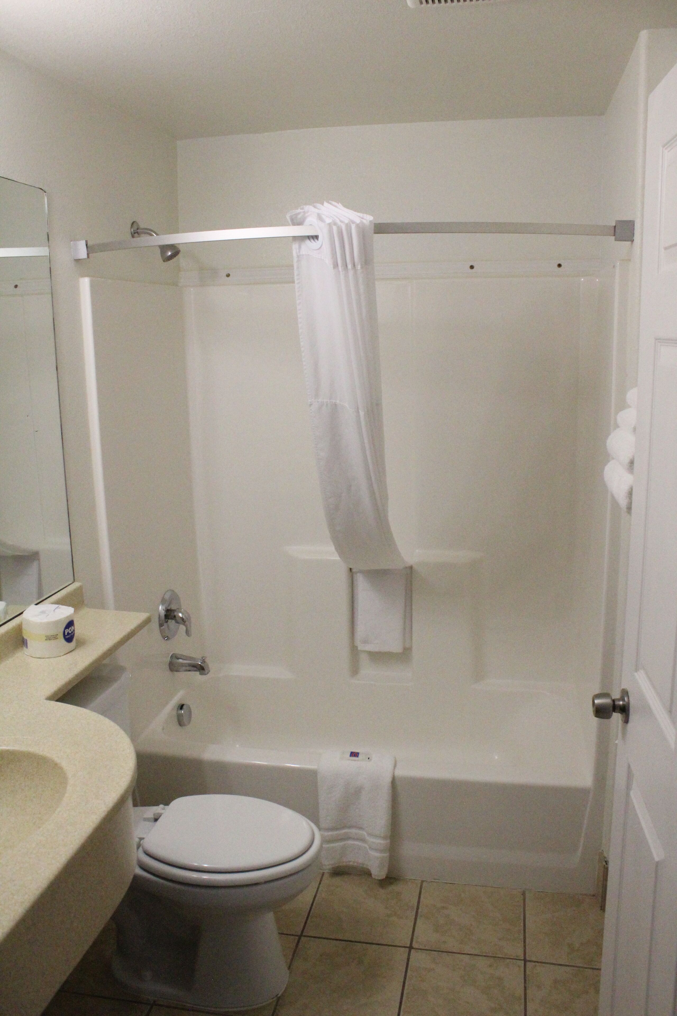 A standard bathroom with a toilet, sink, and bathtub.