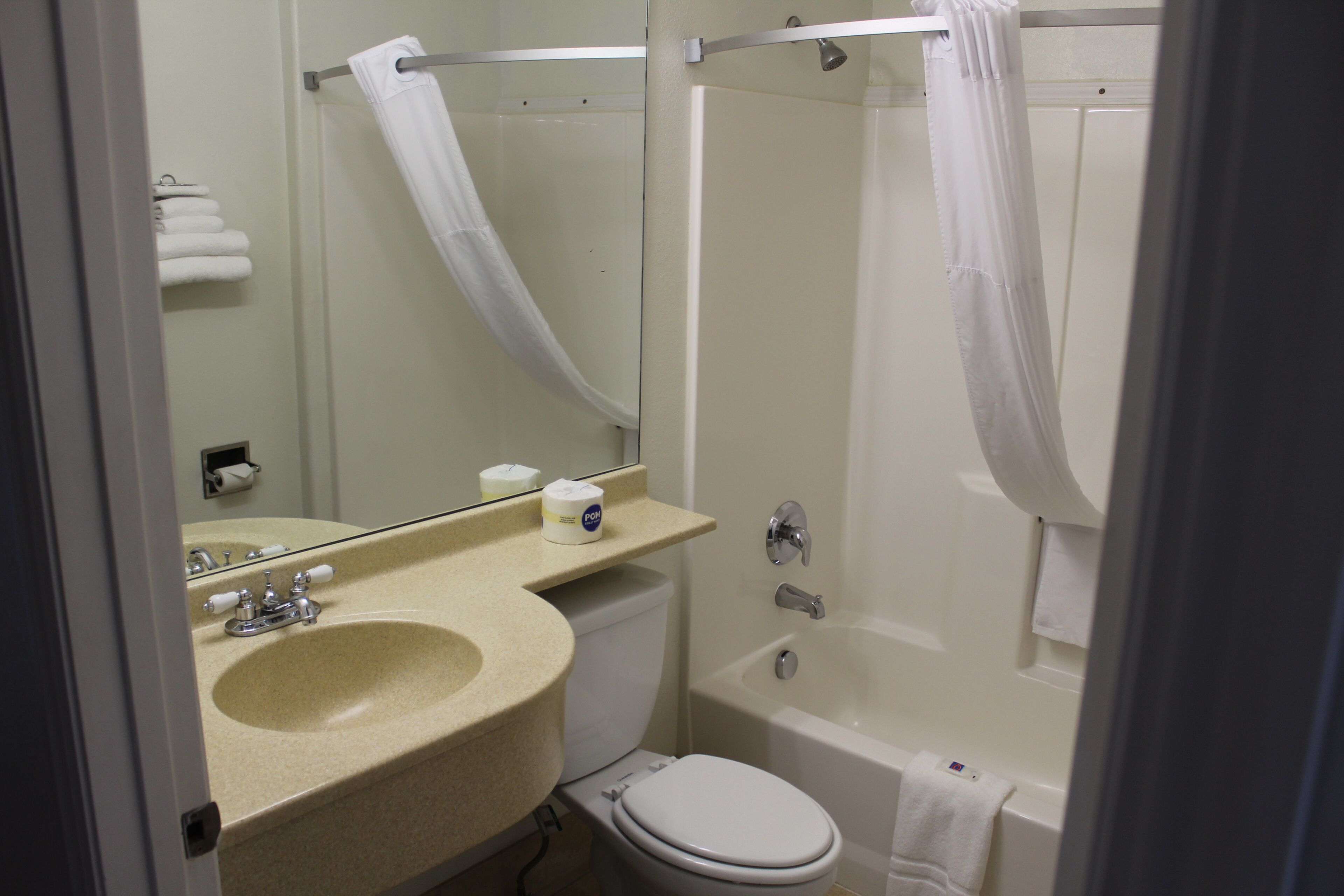 A bathroom with a sink, toilet, and bathtub.