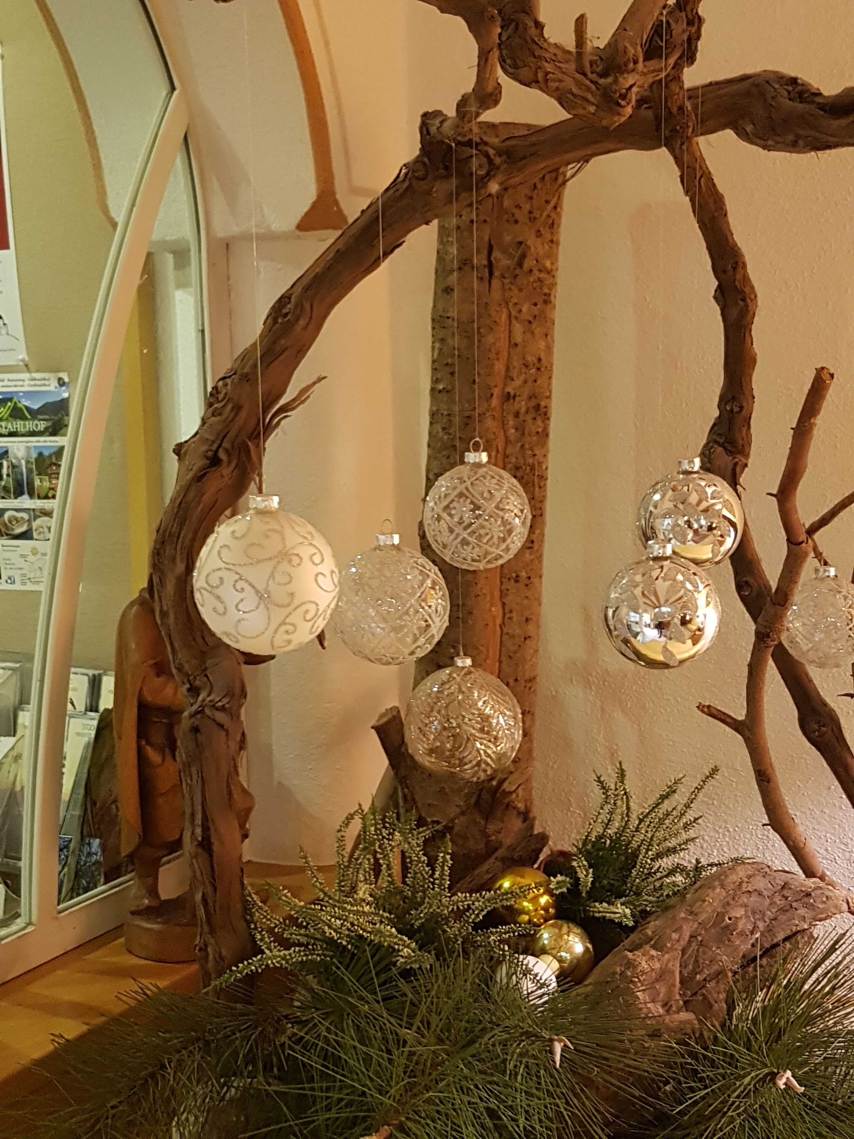 A Christmas tree with ornaments and greenery.