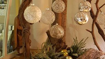 A Christmas tree with ornaments and greenery.