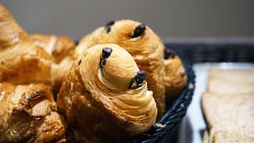 A basket of croissants with chocolate chips.