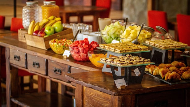 A buffet with various food items and a wooden counter with drawers. - Sent Calafate (El Calafate)