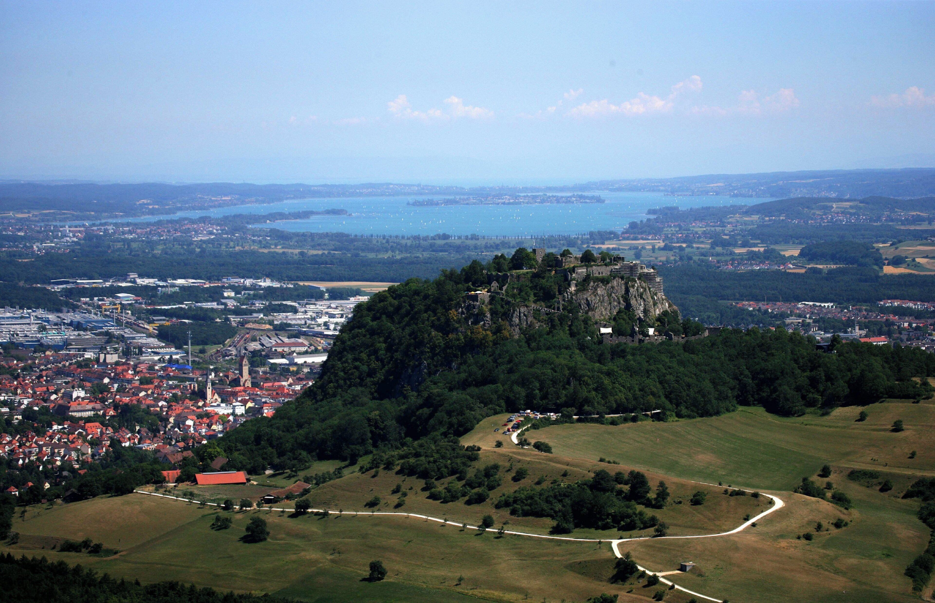 A town with a prominent hilltop castle overlooking a body of water.