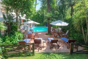 A poolside area with lounge chairs, umbrellas, and a pool. - Hotel Kyrton (Forte dei Marmi)