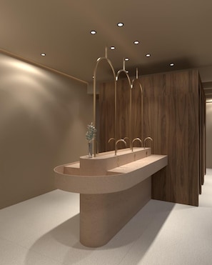 A modern bathroom with a central sink, wooden paneling, and recessed lighting.