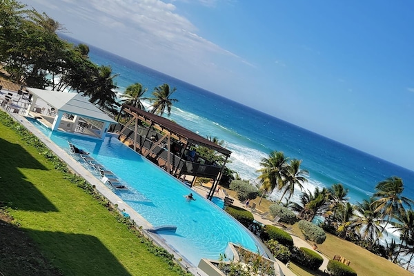 Outdoor pool, open 7:00 AM to 10:00 PM, pool umbrellas, sun loungers