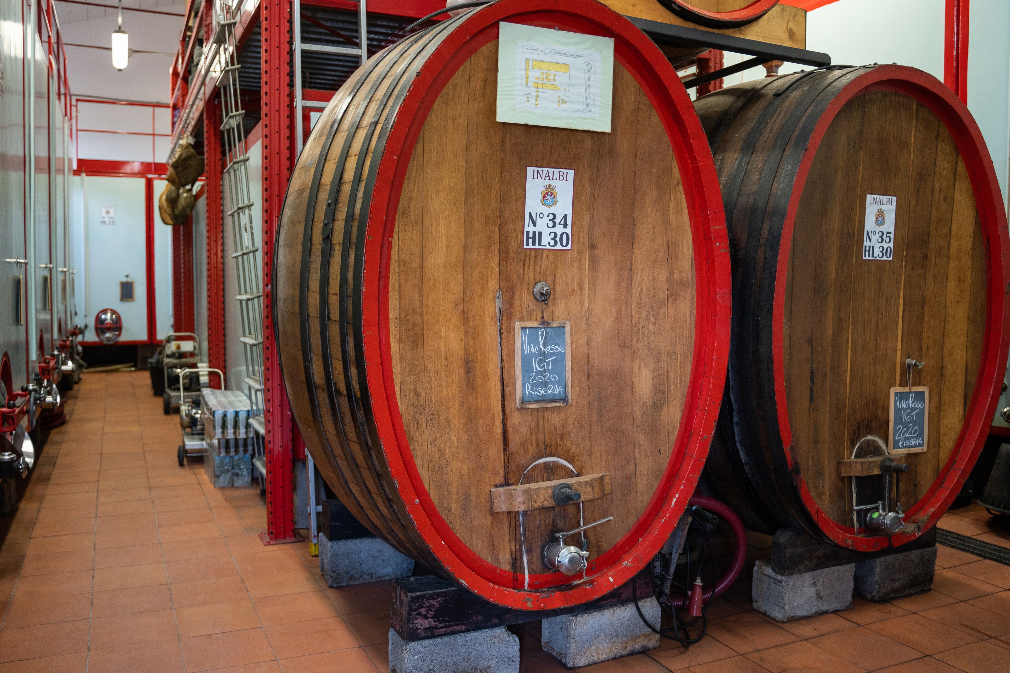 Two large wooden barrels with metal hoops, each labeled with a number and a year.