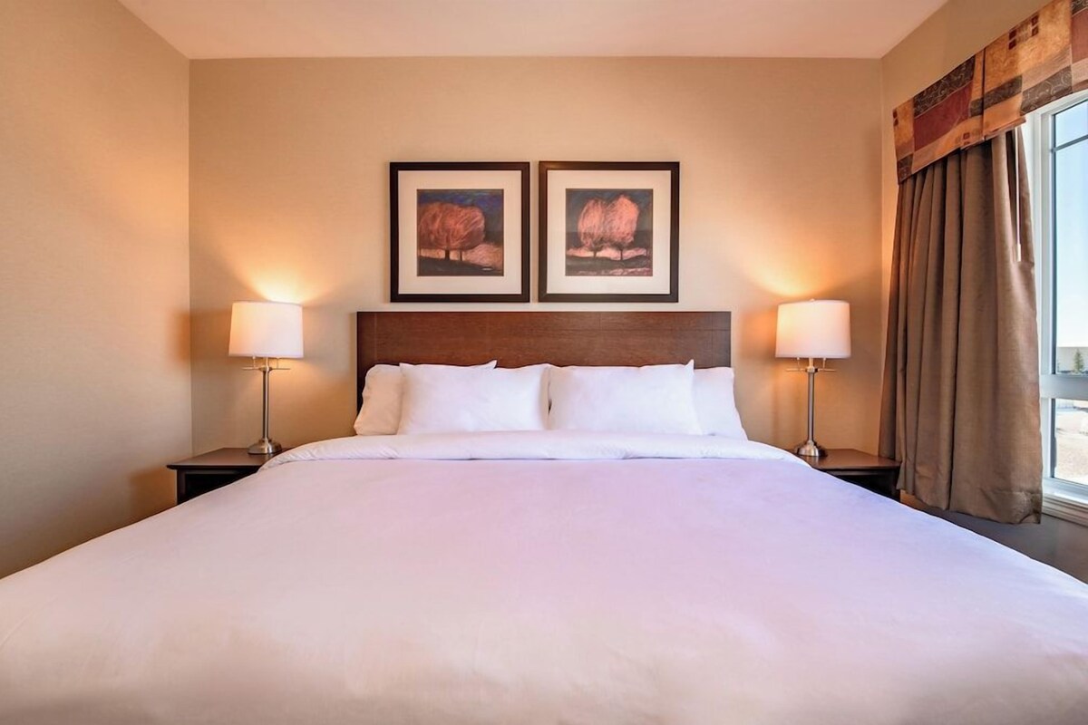 Premium bedding, desk, laptop workspace, iron/ironing board