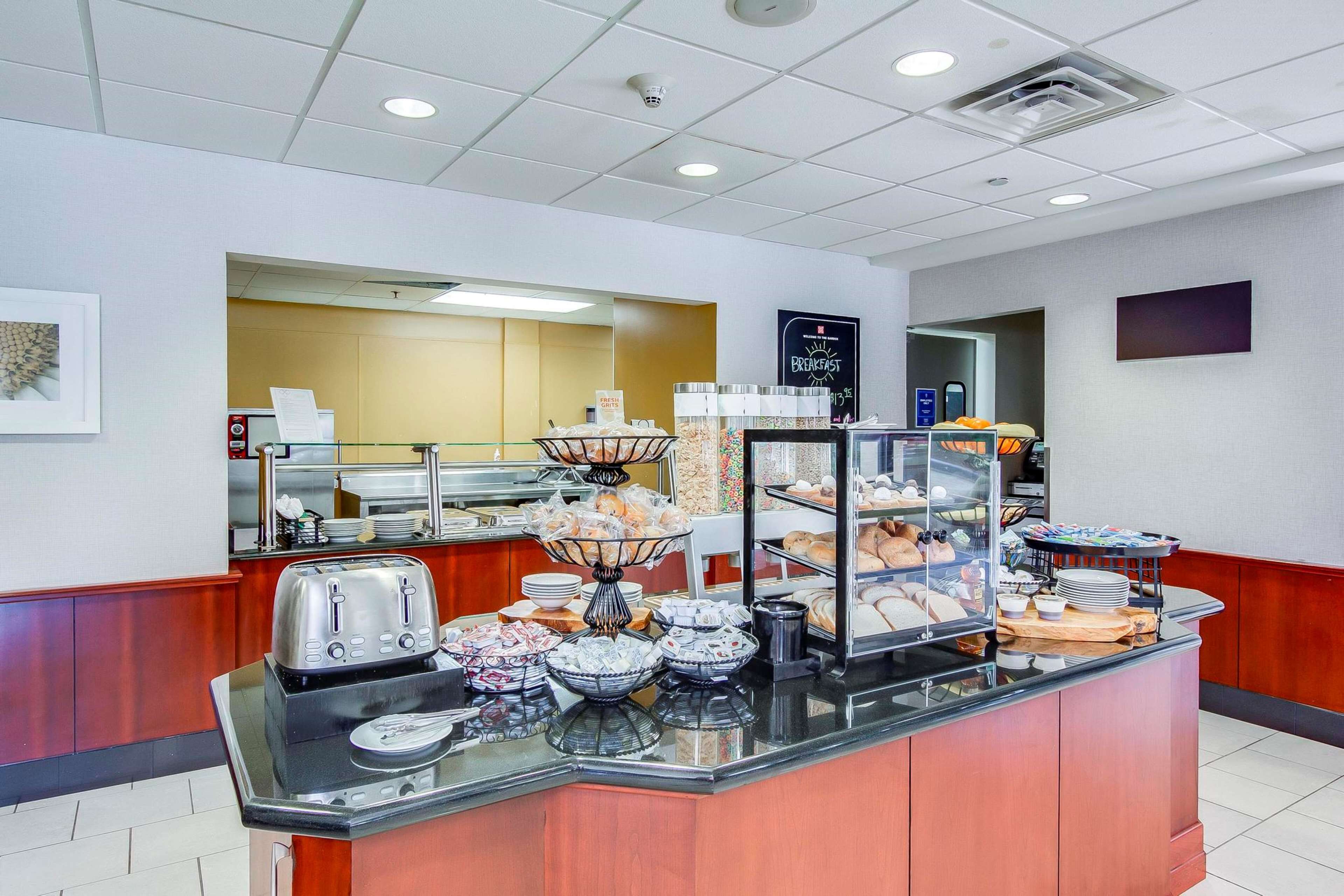 A breakfast buffet with various food items and a coffee station.