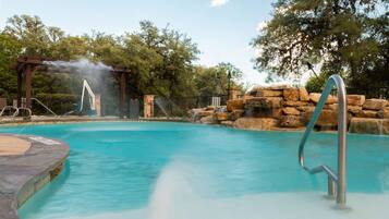 Una piscina al aire libre, sillones reclinables de piscina