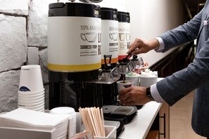 A coffee machine with a label stating '100% Arabica Beans' and 'Sourced from Central America & South America.' - Hampton Inn & Suites Boerne (Boerne)