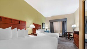 A hotel room with two beds, a desk, a chair, a dresser, and a large mirror. - Best Western Hebbronville Inn (Hebbronville)