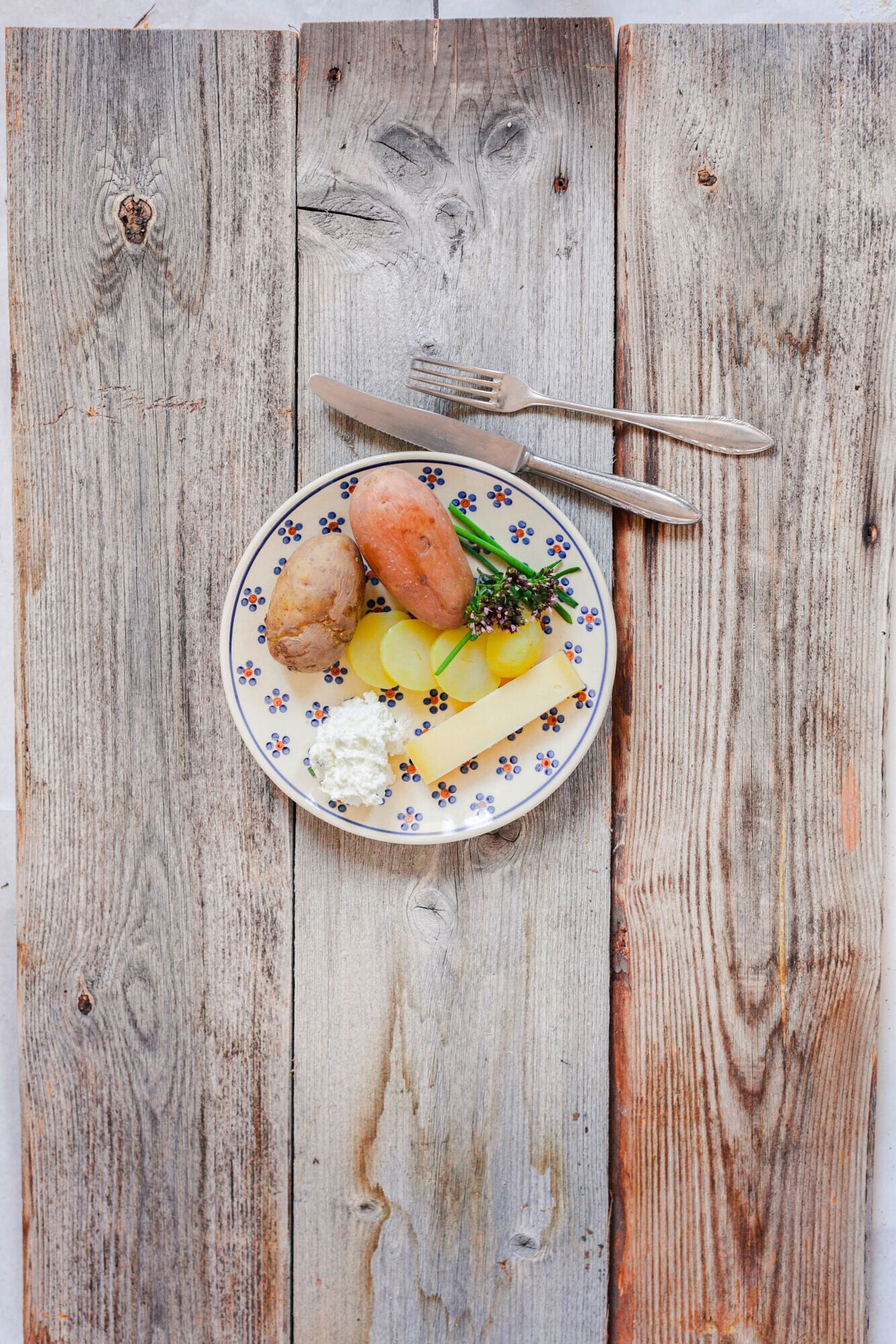 A plate with food items on a wooden table.