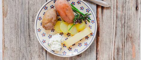 A plate with food items on a wooden table.