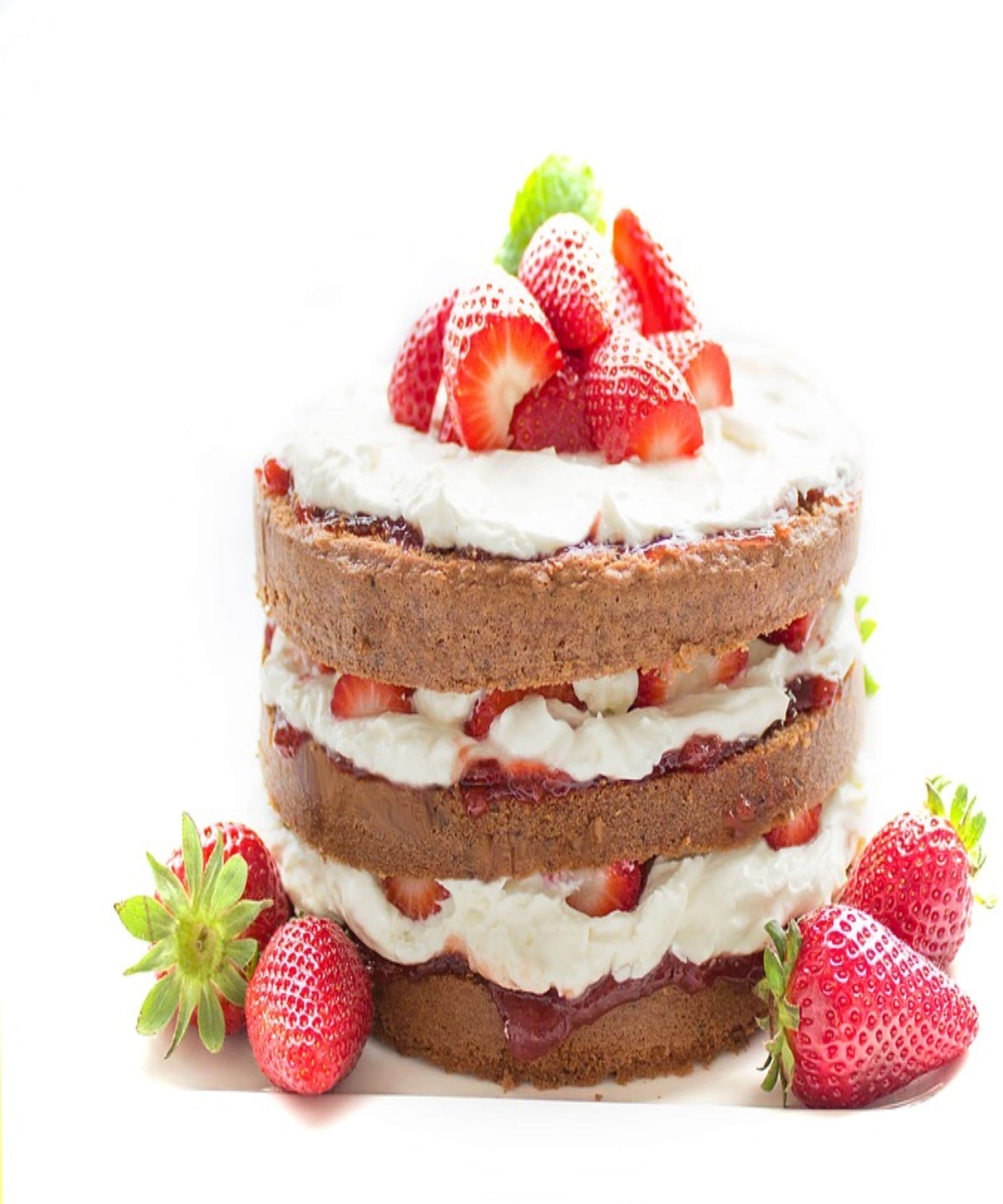 A layered cake with strawberries and cream.