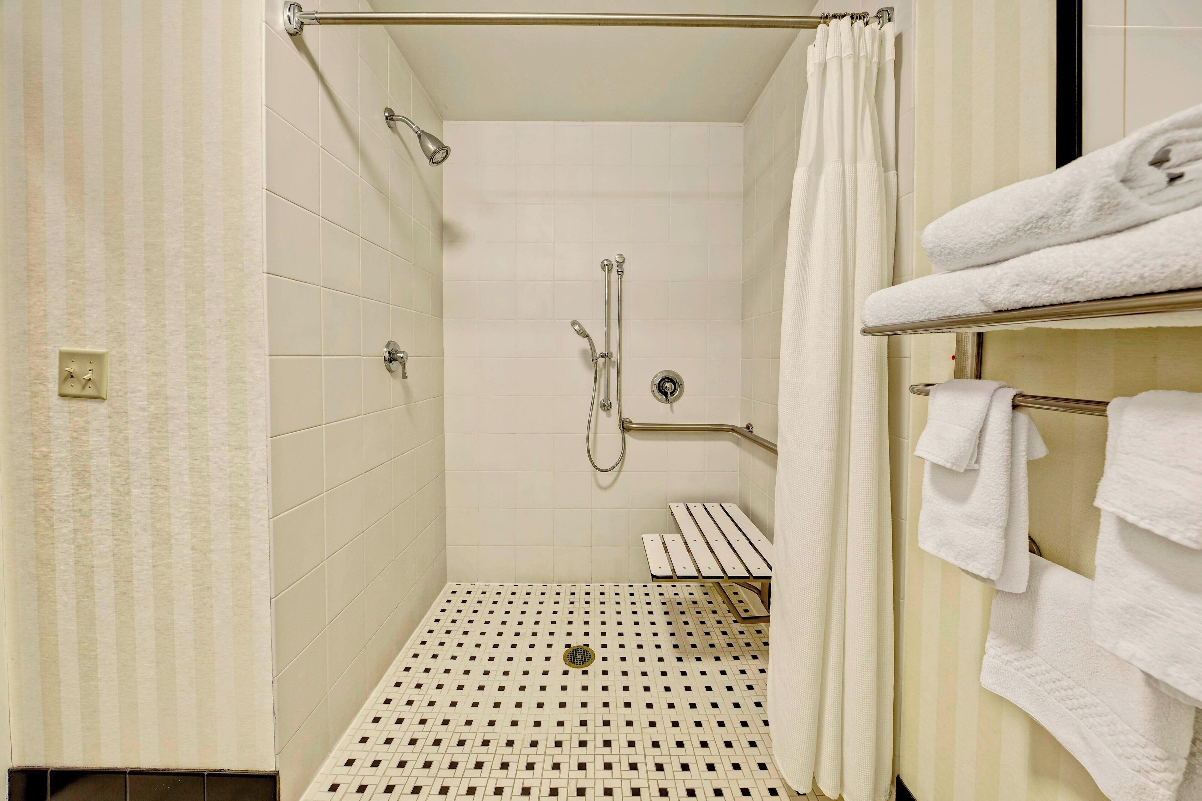 standard room, 1 king bed (mobility accessible, roll-in shower) | bathroom | combined shower/bathtub, designer toiletries, hair dryer, towels