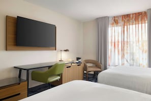A hotel room with a bed, a desk with a chair, a television, and a window with curtains. - Fairfield Inn & Suites by Marriott Memphis Olive Branch (Olive Branch)