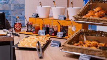 A breakfast buffet with various food items and condiments.