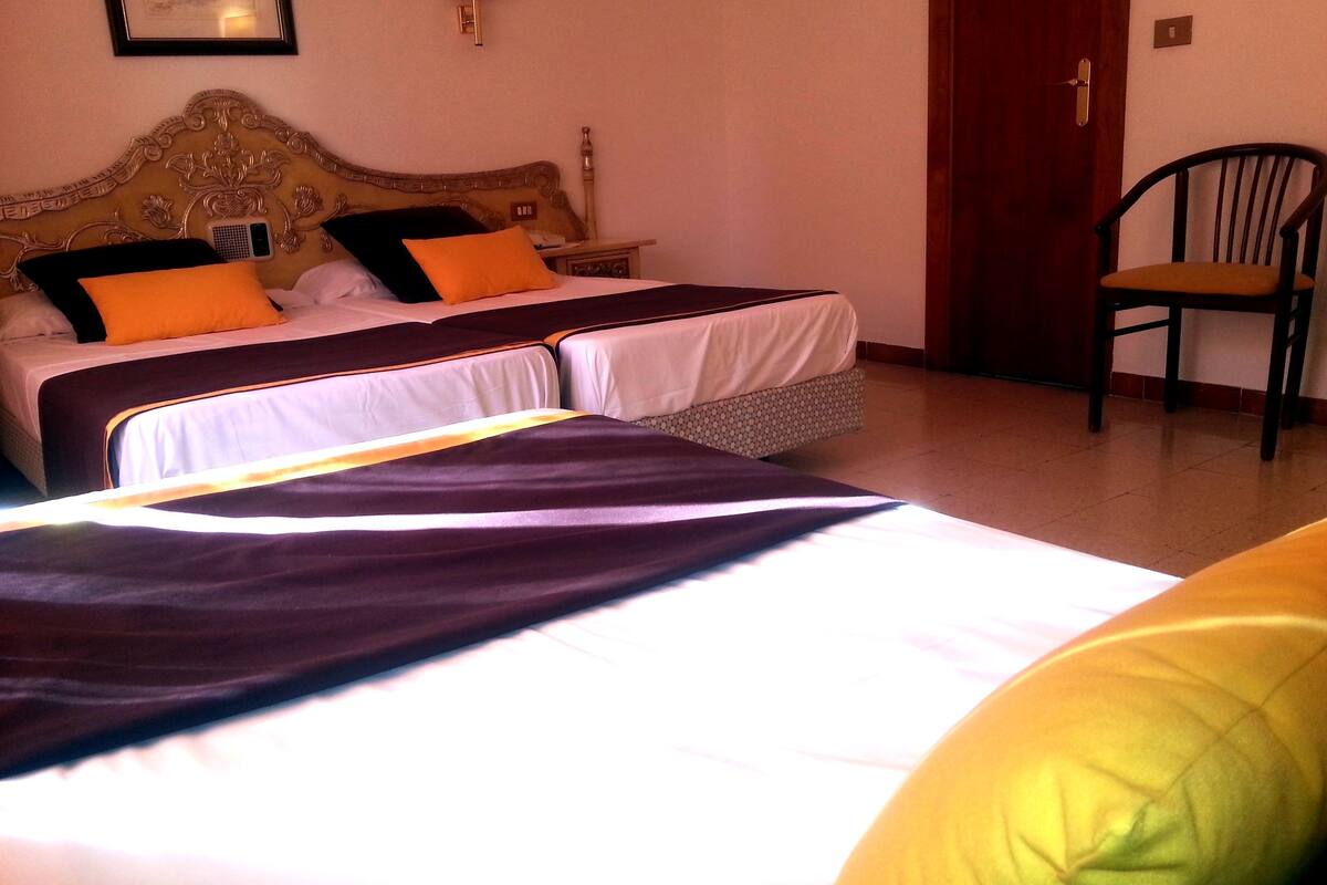 triple room (2 adults and 1 child) | select comfort beds, desk, iron/ironing board, cots/infant beds