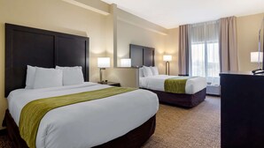 A hotel room with two beds, a desk, and a large mirror. - Comfort Inn & Suites Montgomery Eastchase (Montgomery)