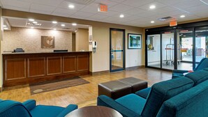 A hotel lobby with a reception desk, seating area, and glass doors leading to the outside. - Comfort Inn & Suites Montgomery Eastchase (Montgomery)