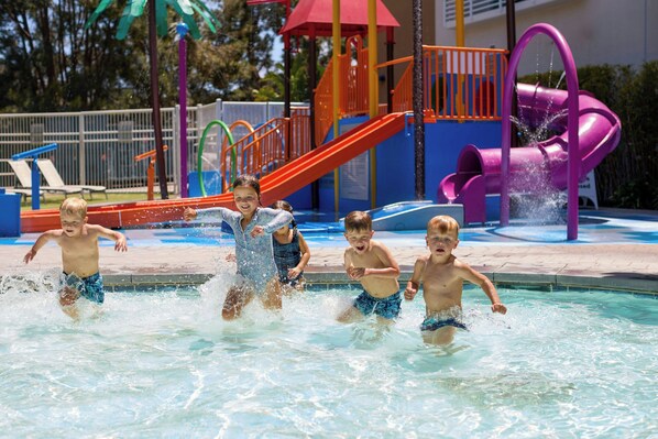 A swimming pool area with slides and a water play structure. - Renaissance ClubSport Aliso Viejo Laguna Beach Hotel (Aliso Viejo)