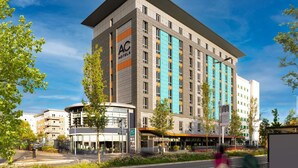 A modern hotel with a prominent AC logo, multiple floors, and a mix of glass and solid facade. - AC Hotel by Marriott, Manchester Salford Quays (Salford)