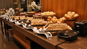 A buffet with various food items and utensils.