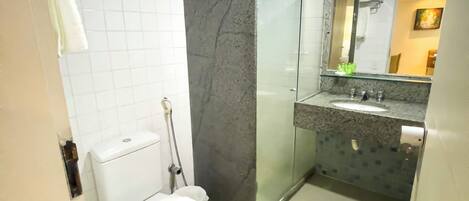 A modern bathroom with a toilet, sink, and shower.